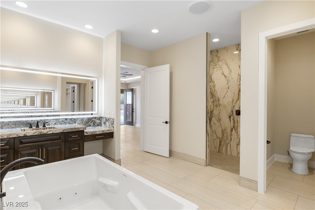 9865 Bright Angel Way Las Vegas, NV 89149 - Photo 51 of 98 Bathroom featuring a marble finish shower, vanity, a whirlpool tub, toilet, and recessed lighting