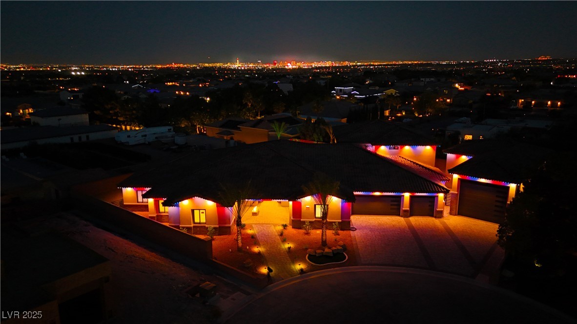 9865 Bright Angel Way Las Vegas, NV 89149 - Photo 6 of 98 Patio at night featuring a view of city lights