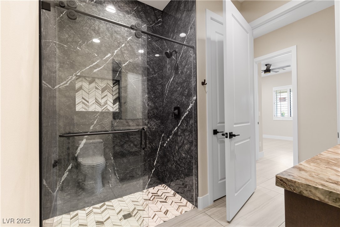 9865 Bright Angel Way Las Vegas, NV 89149 - Photo 77 of 98 Casita 1 Full bath with a marble finish shower, toilet, and tile patterned floors