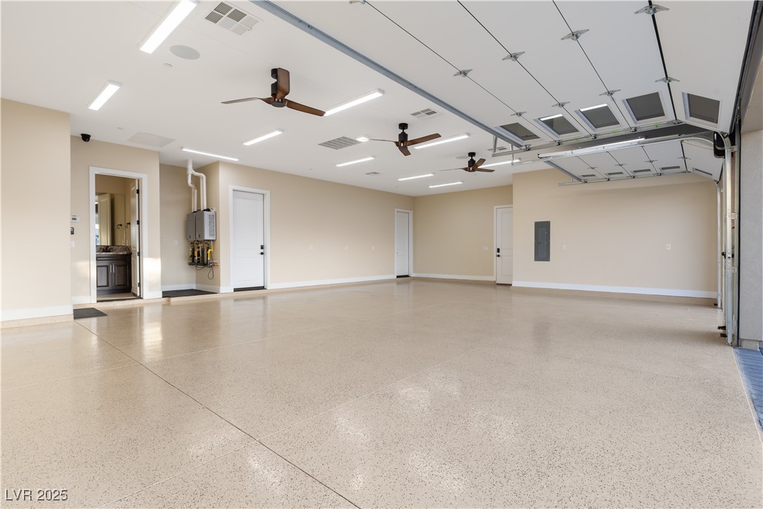 9865 Bright Angel Way Las Vegas, NV 89149 - Photo 95 of 98 1068 sq ft 3 Car Garage, 18' X 8' and 9' X 8' Steel Back Insulated Doors, with Wall Mounted Torsion Openers, Spray Foam Walls and Lid, HVAC Thermostatically Controlled, 50 Amp 220V EV Outlet, Surveillance, Alarm, 1/2 Bath, Epoxy Floors, Base Molding, LED Lighting Package, 3 Ceiling Fans, Dual Rinnai Tankless Hot Water Heaters w/Timer