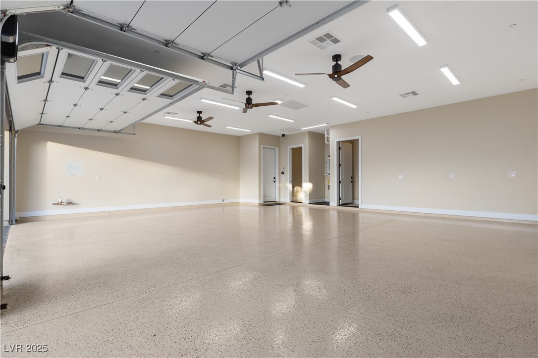 9865 Bright Angel Way Las Vegas, NV 89149 - Photo 96 of 98 1068 sq ft 3 Car Garage, 18' X 8' and 9' X 8' Steel Back Insulated Doors, with Wall Mounted Torsion Openers, Spray Foam Walls and Lid, HVAC Thermostatically Controlled, 50 Amp 220V EV Outlet, Surveillance, Alarm, 1/2 Bath, Epoxy Floors, Base Molding, LED Lighting Package, 3 Ceiling Fans, Dual Rinnai Tankless Hot Water Heaters w/Timer