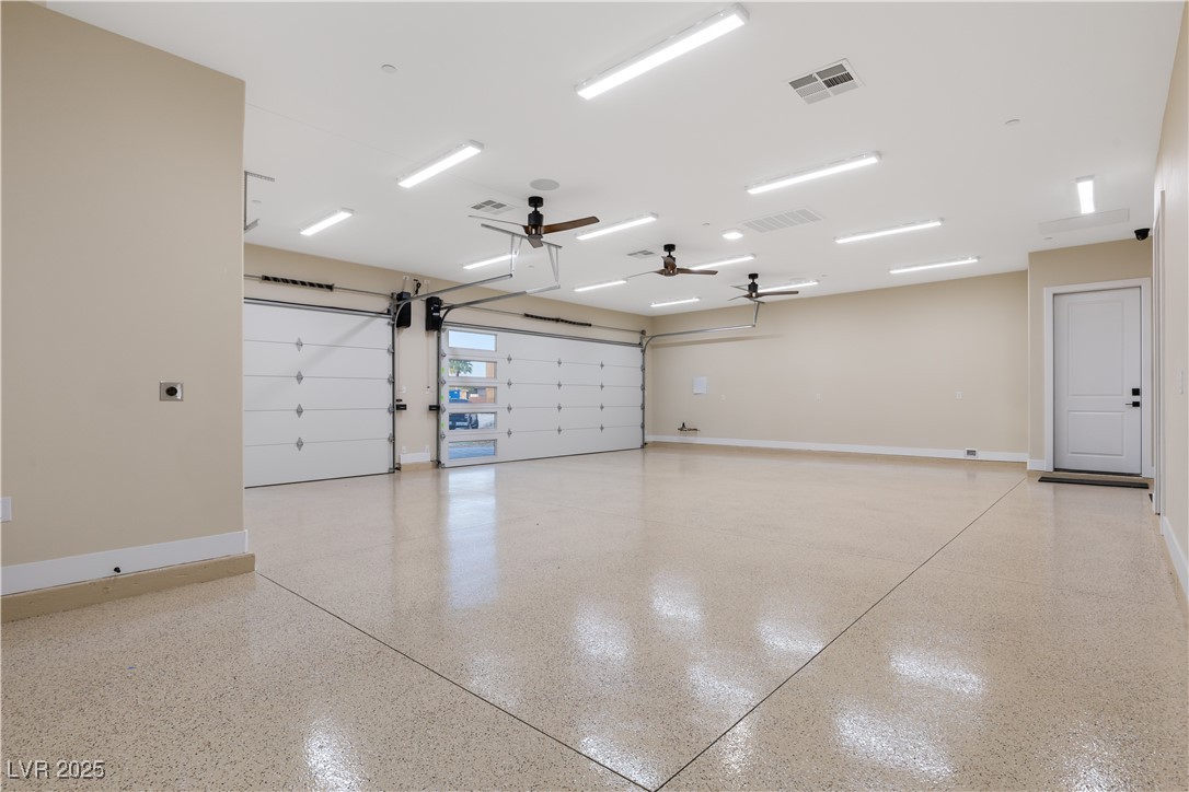 9865 Bright Angel Way Las Vegas, NV 89149 - Photo 97 of 98 1068 sq ft 3 Car Garage, 18' X 8' and 9' X 8' Steel Back Insulated Doors, with Wall Mounted Torsion Openers, Spray Foam Walls and Lid, HVAC Thermostatically Controlled, 50 Amp 220V EV Outlet, Surveillance, Alarm, 1/2 Bath, Epoxy Floors, Base Molding, LED Lighting Package, 3 Ceiling Fans, Dual Rinnai Tankless Hot Water Heaters w/Timer