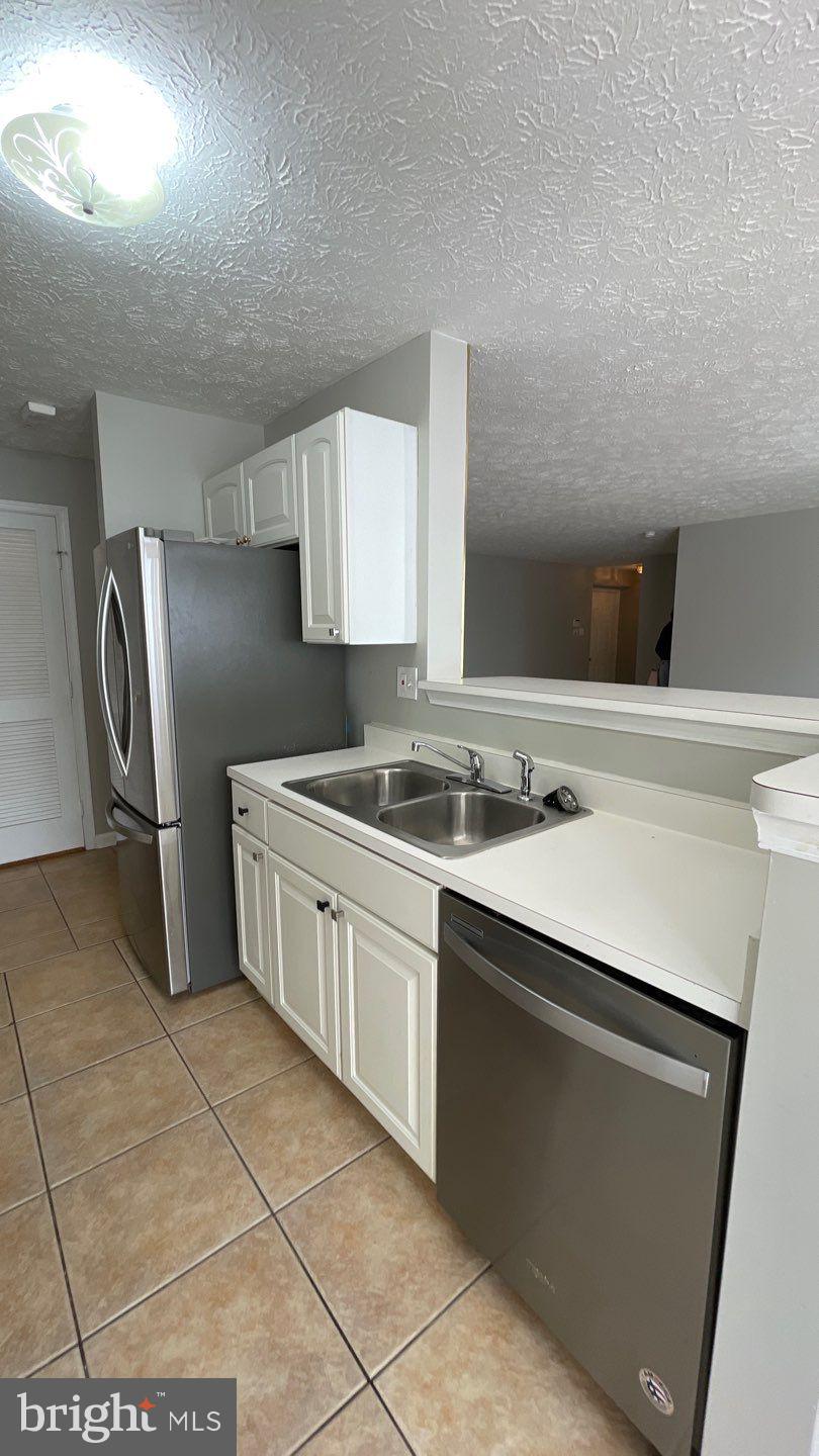 4915 Riders Court, Unit 4915 Owings Mills, MD 21117 - Photo 11 of 25 a kitchen with stainless steel appliances a sink stove and refrigerator