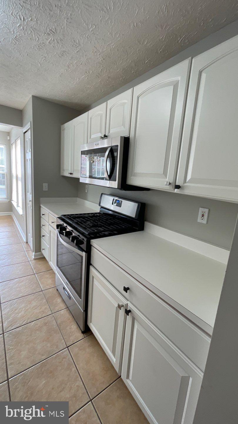 4915 Riders Court, Unit 4915 Owings Mills, MD 21117 - Photo 13 of 25 a kitchen with cabinets and appliances