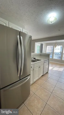 a kitchen with stainless steel appliances a refrigerator sink and cabinets