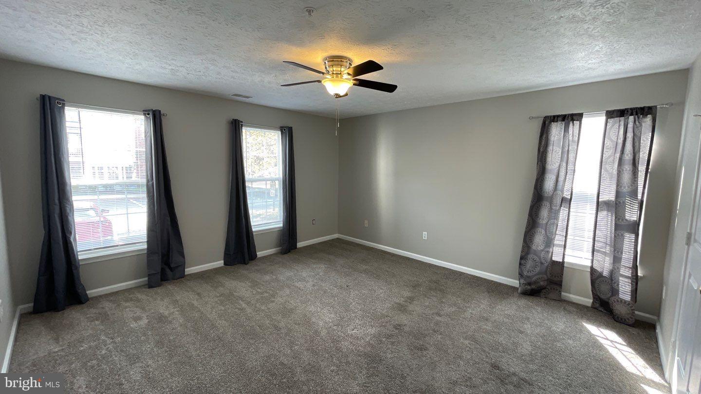 4915 Riders Court, Unit 4915 Owings Mills, MD 21117 - Photo 17 of 25 an empty room with windows and closet