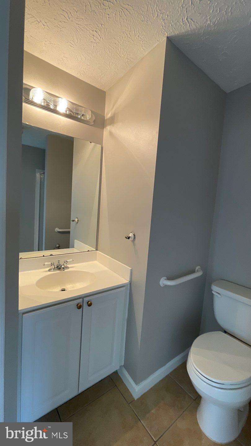 4915 Riders Court, Unit 4915 Owings Mills, MD 21117 - Photo 22 of 25 a bathroom with a granite countertop sink toilet and shower