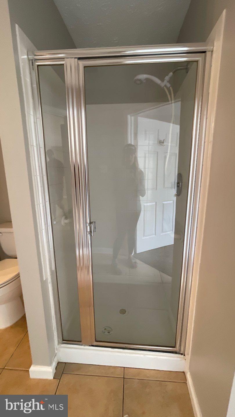 4915 Riders Court, Unit 4915 Owings Mills, MD 21117 - Photo 24 of 25 a bathroom with a glass shower door