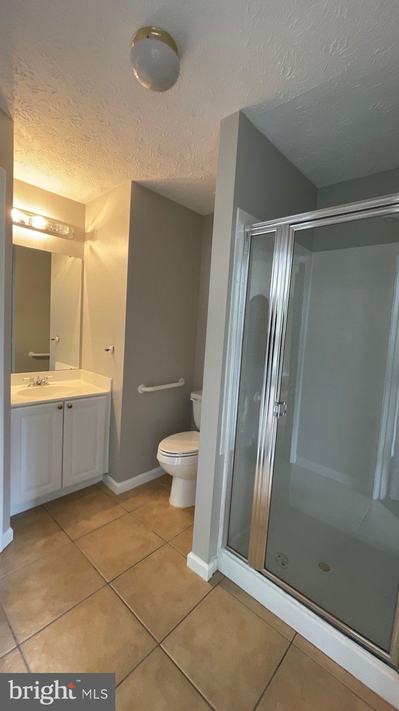 4915 Riders Court, Unit 4915 Owings Mills, MD 21117 - Photo 25 of 25 a bathroom with a double vanity sink toilet and shower