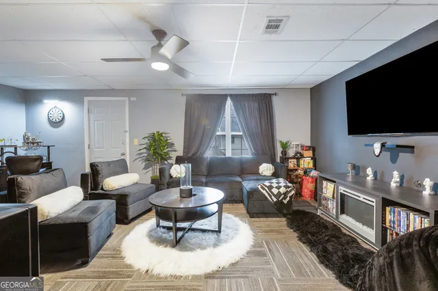 a living room with furniture and a flat screen tv