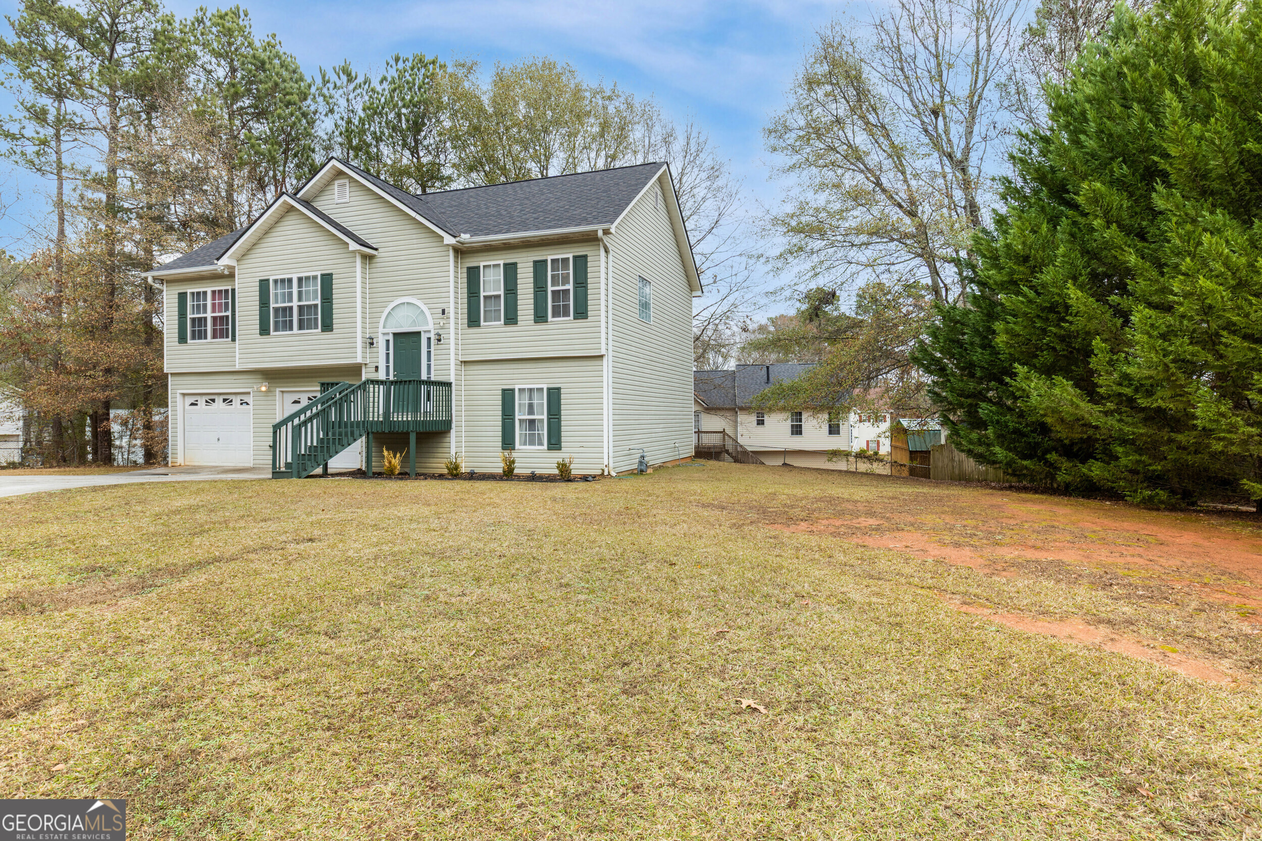 159 Villa Rosa Ridge Temple, GA 30179 - Photo 30 of 31 a view of a white house with a yard and large trees
