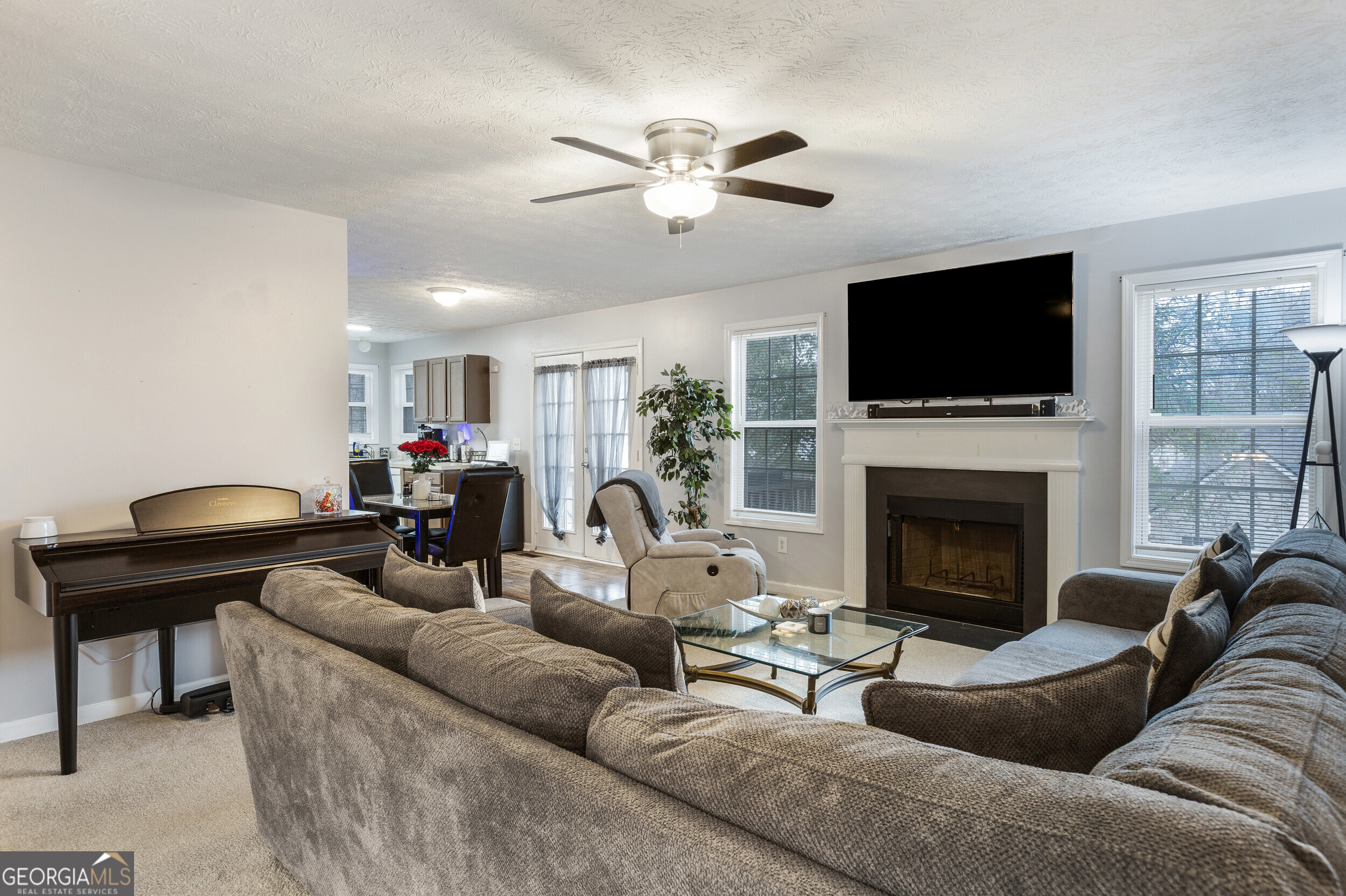159 Villa Rosa Ridge Temple, GA 30179 - Photo 4 of 31 a living room with furniture a fireplace and a flat screen tv