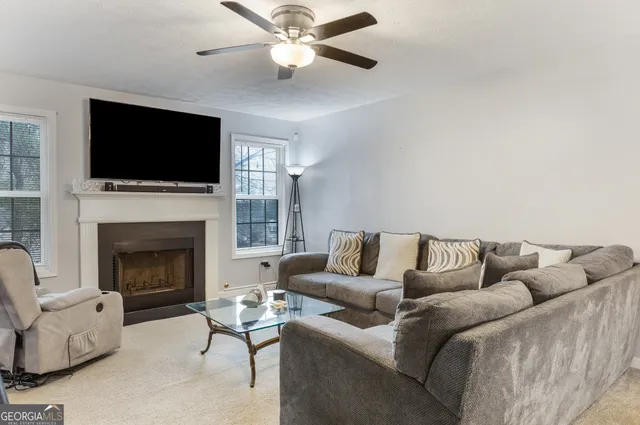 a living room with furniture fireplace and flat screen tv