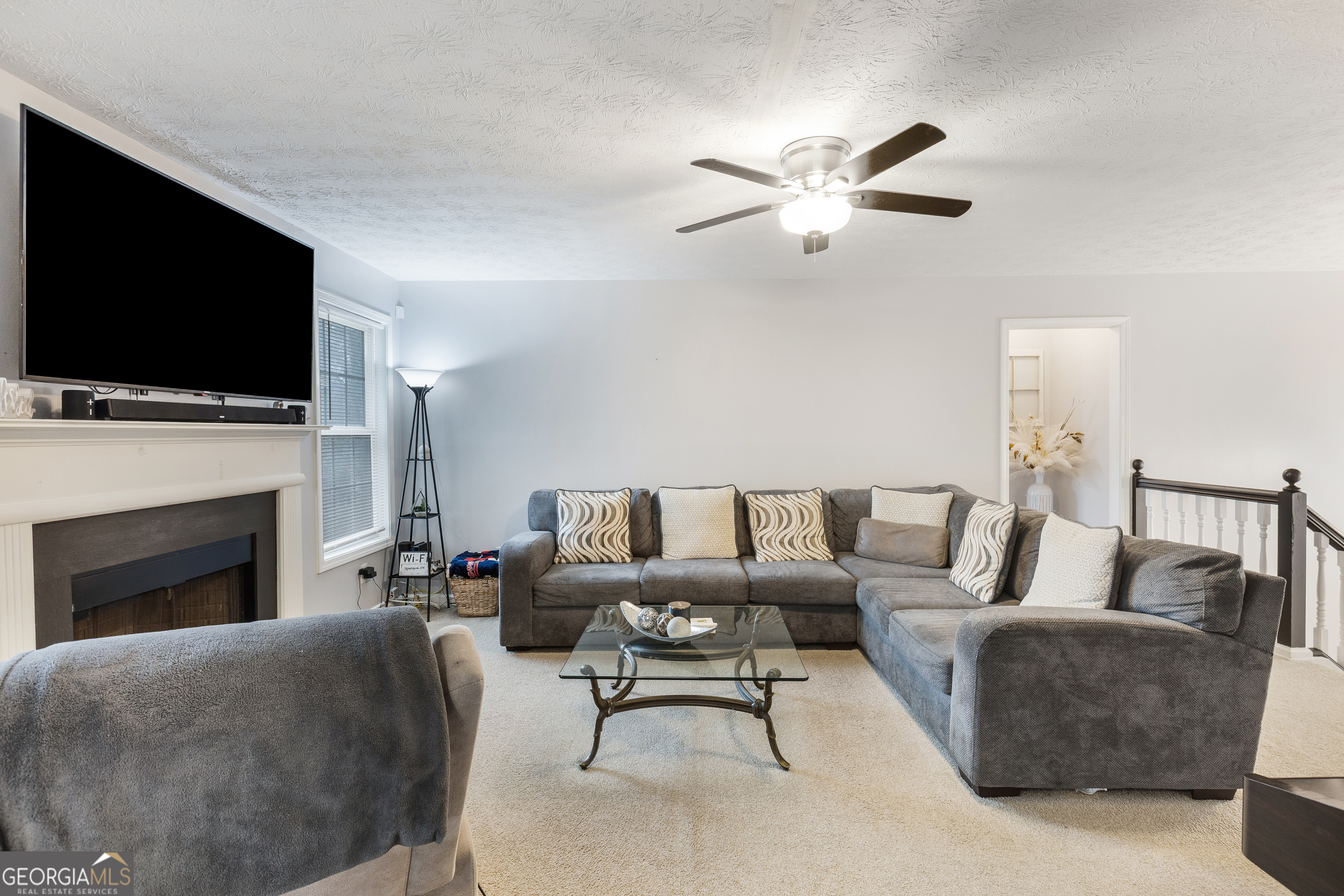 159 Villa Rosa Ridge Temple, GA 30179 - Photo 6 of 31 a living room with furniture a fireplace and a flat screen tv