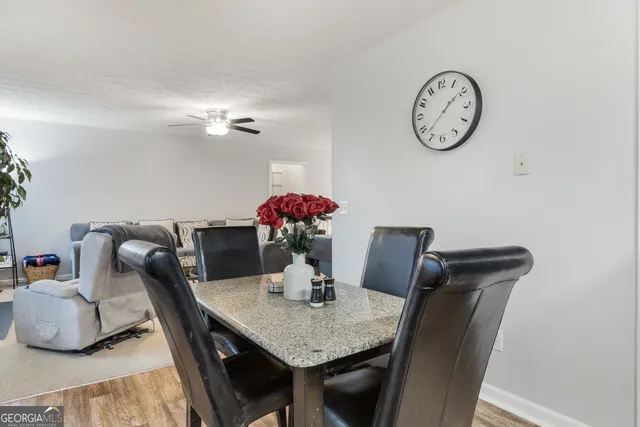 a view of a dining room with furniture and wooden floor