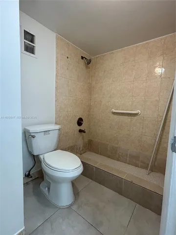 a bathroom with a toilet and shower