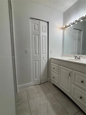 a spacious bathroom with a double vanity sink a mirror and a shower
