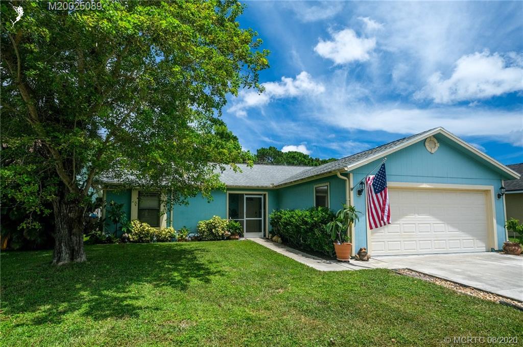 4063 Southeast Jacaranda Street Stuart, FL 34997 - Photo 1 of 34 a front view of house with yard and green space