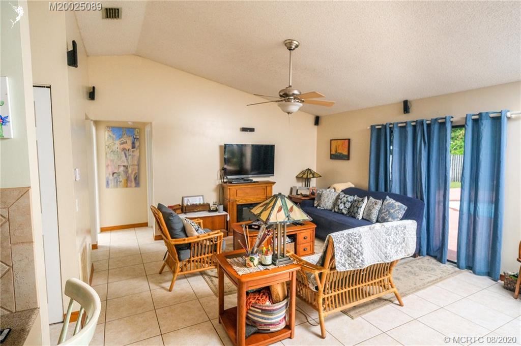 4063 Southeast Jacaranda Street Stuart, FL 34997 - Photo 15 of 34 a living room with furniture and a flat screen tv