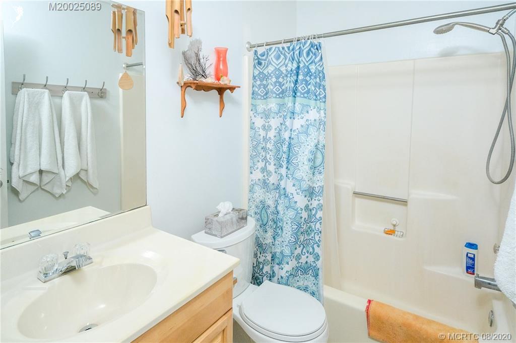 4063 Southeast Jacaranda Street Stuart, FL 34997 - Photo 17 of 34 a bathroom with a sink toilet and shower