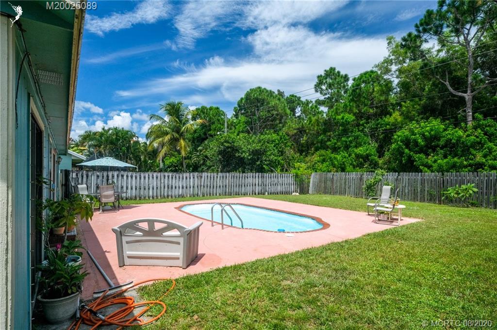 4063 Southeast Jacaranda Street Stuart, FL 34997 - Photo 21 of 34 a view of a backyard with swimming pool