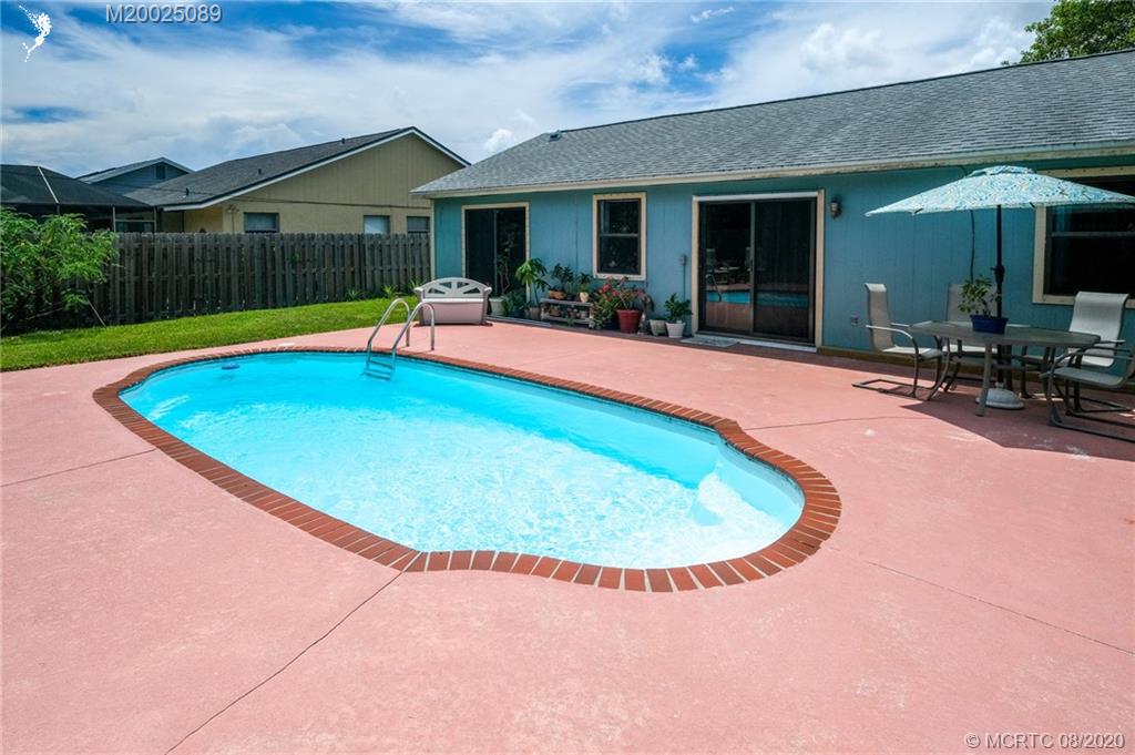 4063 Southeast Jacaranda Street Stuart, FL 34997 - Photo 22 of 34 a view of swimming pool in front of house