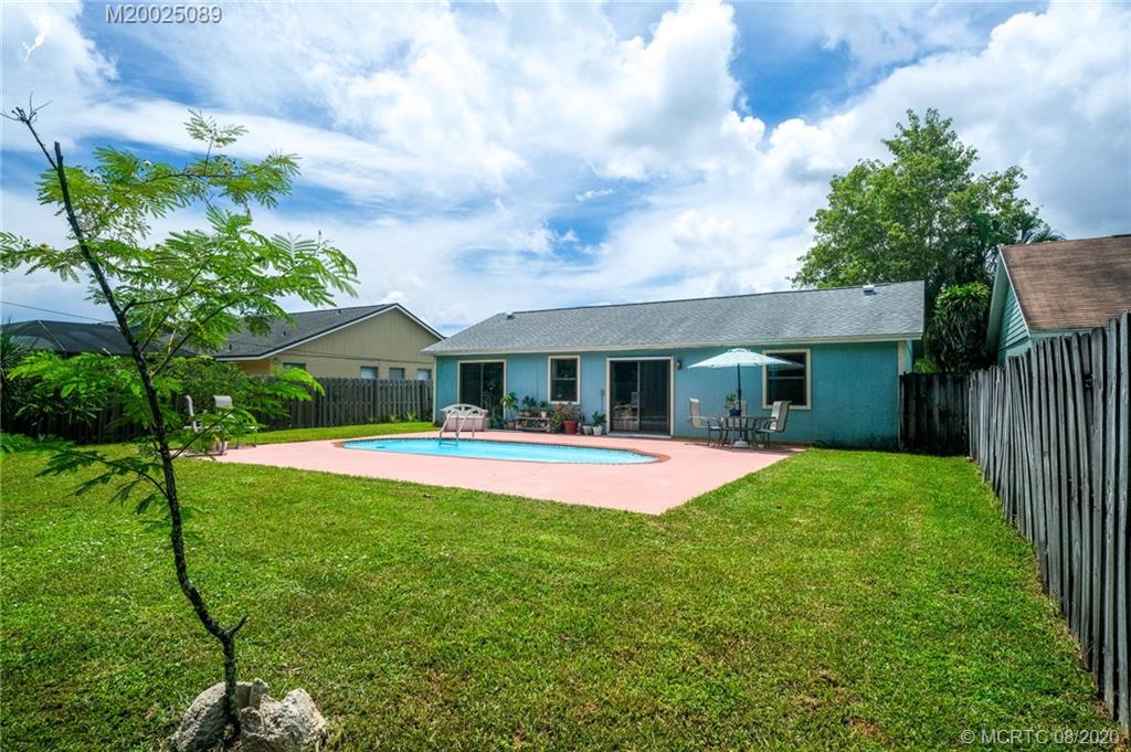 4063 Southeast Jacaranda Street Stuart, FL 34997 - Photo 23 of 34 a front view of house with yard and green space