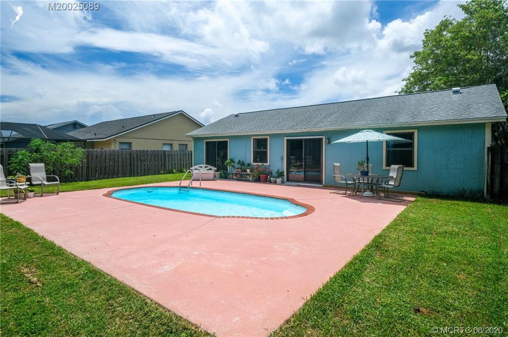 4063 Southeast Jacaranda Street Stuart, FL 34997 - Photo 24 of 34 a swimming pool with outdoor seating yard and barbeque oven