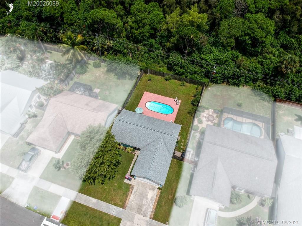 4063 Southeast Jacaranda Street Stuart, FL 34997 - Photo 25 of 34 an aerial view of a house with a yard basket ball court