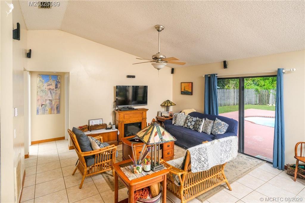 4063 Southeast Jacaranda Street Stuart, FL 34997 - Photo 4 of 34 a living room with furniture and a flat screen tv