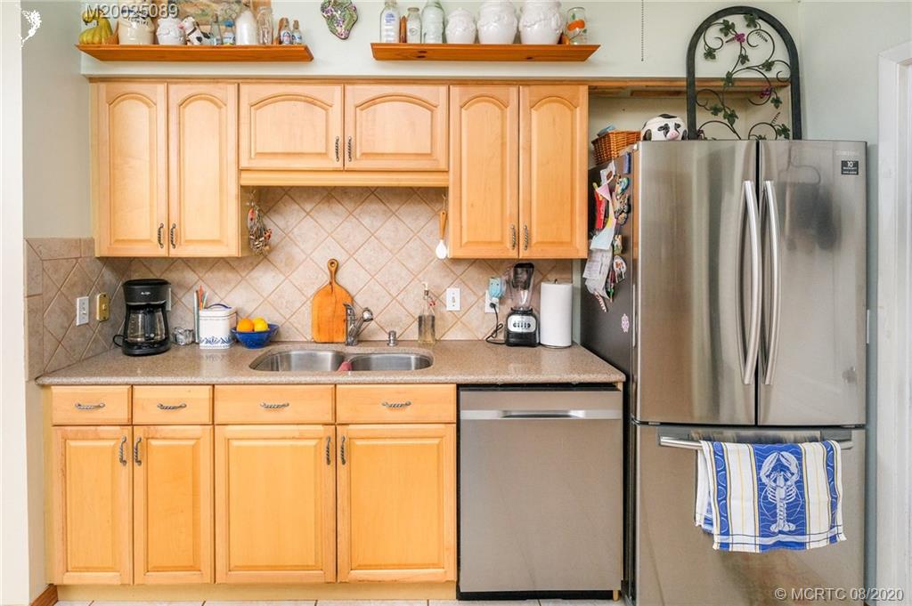 4063 Southeast Jacaranda Street Stuart, FL 34997 - Photo 6 of 34 a kitchen with stainless steel appliances granite countertop a refrigerator and a stove