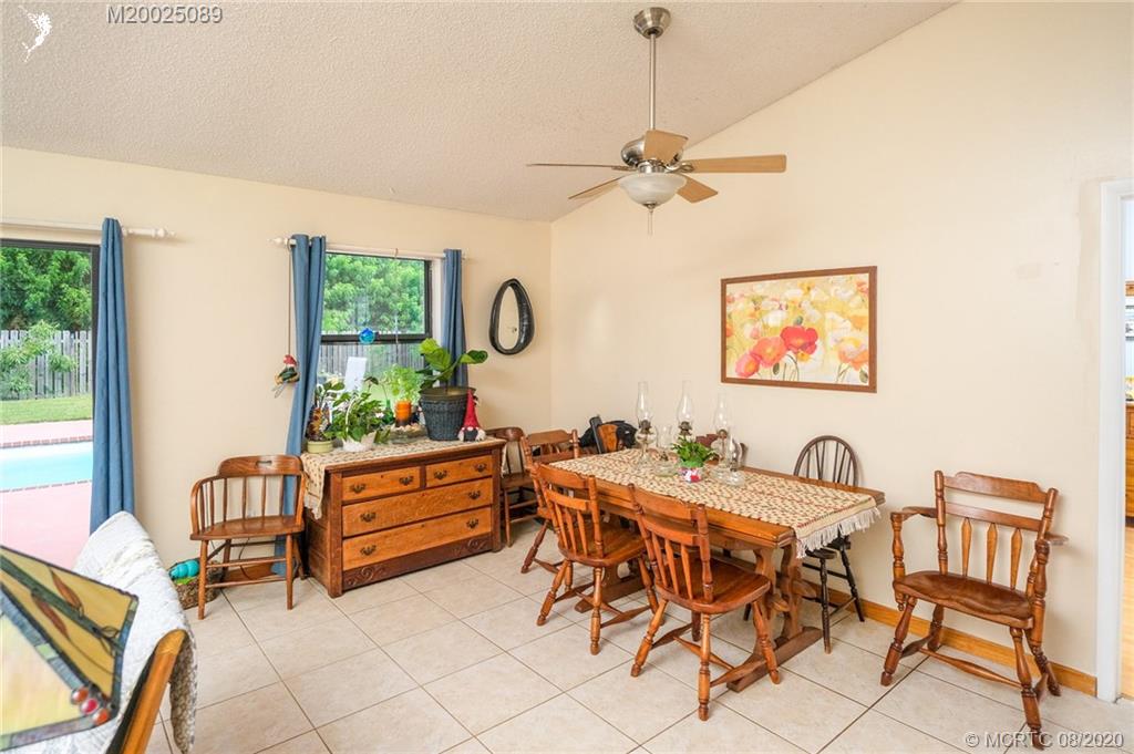 4063 Southeast Jacaranda Street Stuart, FL 34997 - Photo 7 of 34 a view of a dining room with furniture and a window