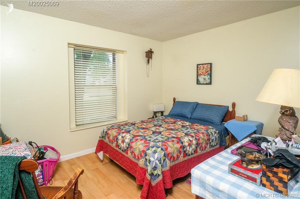 4063 Southeast Jacaranda Street Stuart, FL 34997 - Photo 10 of 34 a bedroom with bed and a window