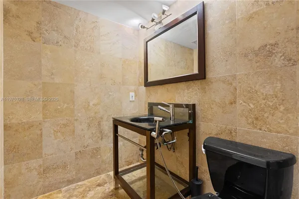 a bathroom with a sink a mirror and a shower