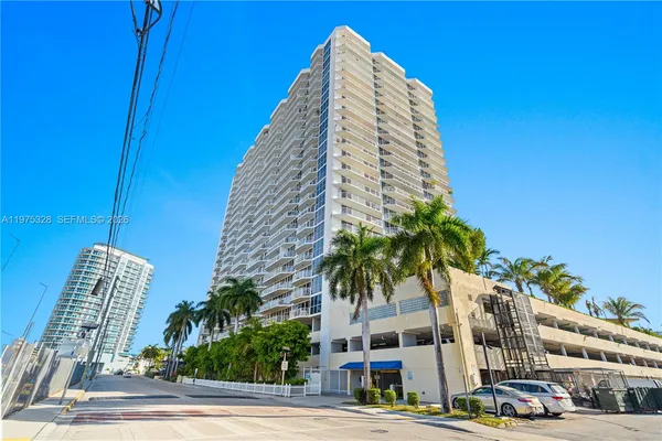 a view of a tall building next to a road