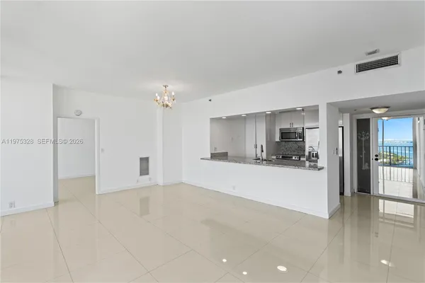 a view of a kitchen with a sink and a refrigerator