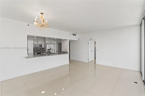 a view of a kitchen with a sink and a refrigerator