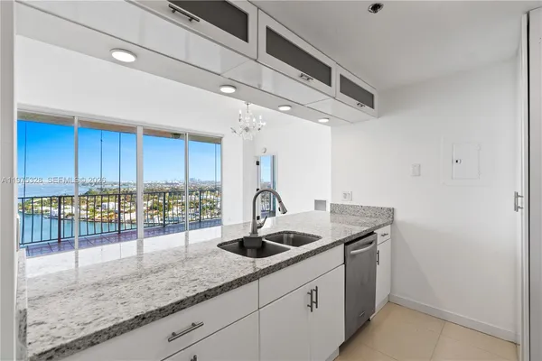 a kitchen with a sink a counter space and cabinets