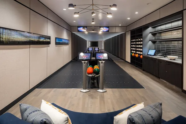 a room with stainless steel appliances granite countertop a sink a stove and a refrigerator