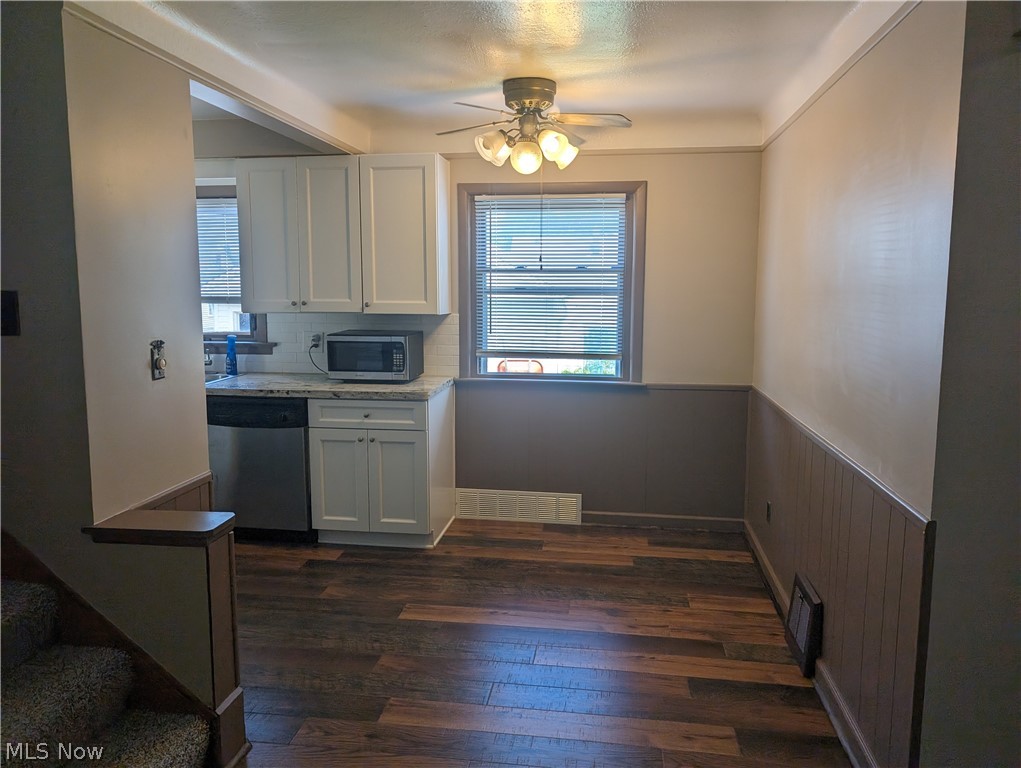 30213 Barjode Road Willowick, OH 44095 - Photo 4 of 20 Kitchen with stainless steel appliances, dark wood-type flooring, white cabinets, and ceiling fan
