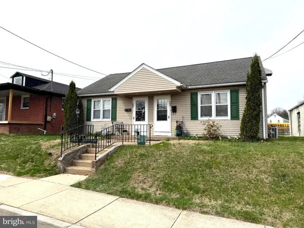 a front view of a house with a garden and patio