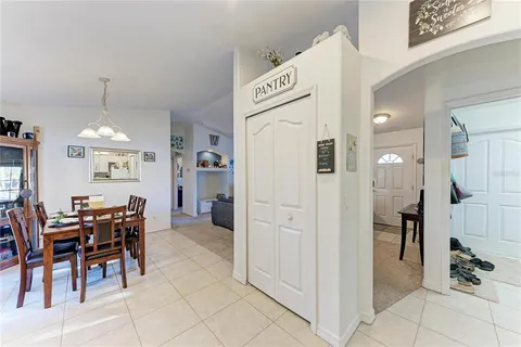a view of kitchen with furniture and refrigerator