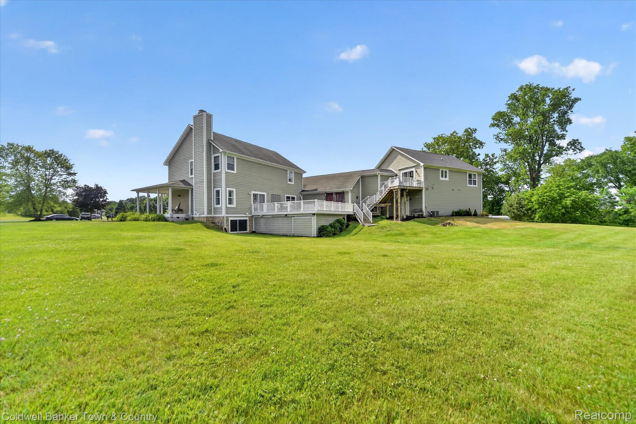 918 Gray Fox Court Howell, MI 48843 - Photo 64 of 84 Spacious green lawn surrounding a two-story residence with light gray siding