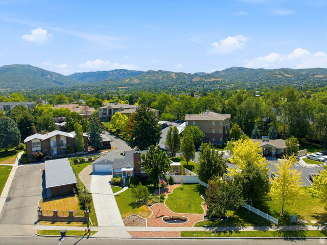 1925 South Main Street Bountiful, UT 84010 - Photo 44 of 48 Expansive property featuring a paved driveway, a two-car garage, and a landscaped front yard with mature trees