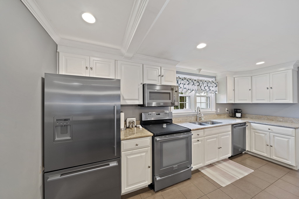 16 Jay Road Weymouth, MA 02190 - Photo 11 of 40 a kitchen with white cabinets stainless steel appliances and sink