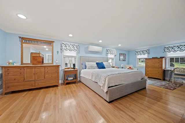 a bedroom with a large bed and a dresser