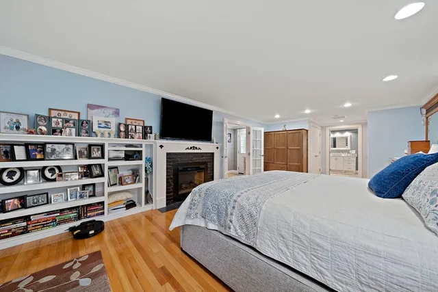 a bedroom with a bed a dresser and a book shelf
