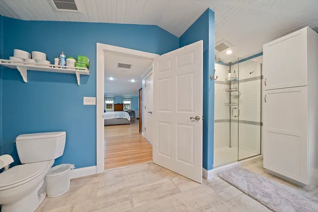 a bathroom with a toilet and a shower