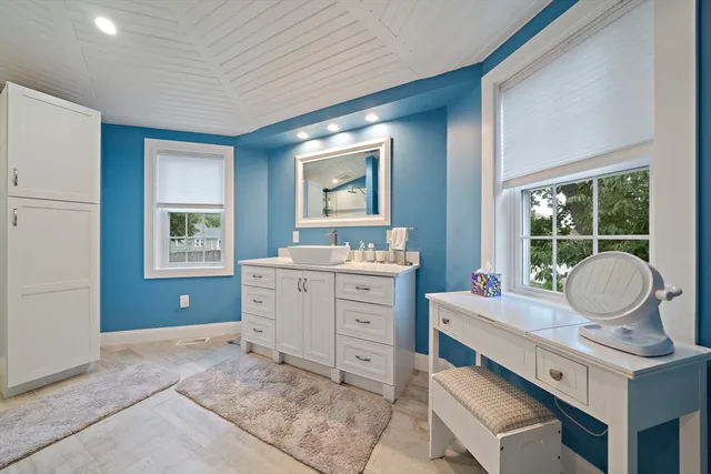 a room with a stove a sink and a window