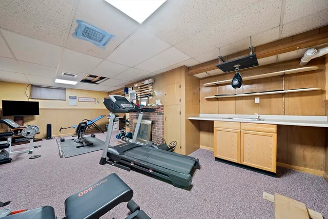 a room with gym equipment and a flat screen tv